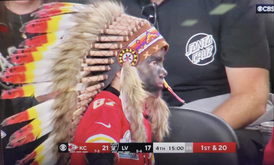 Fan dressed in blackface and headdress