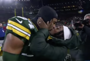 Simone Biles kicks off the game by kissing her husband